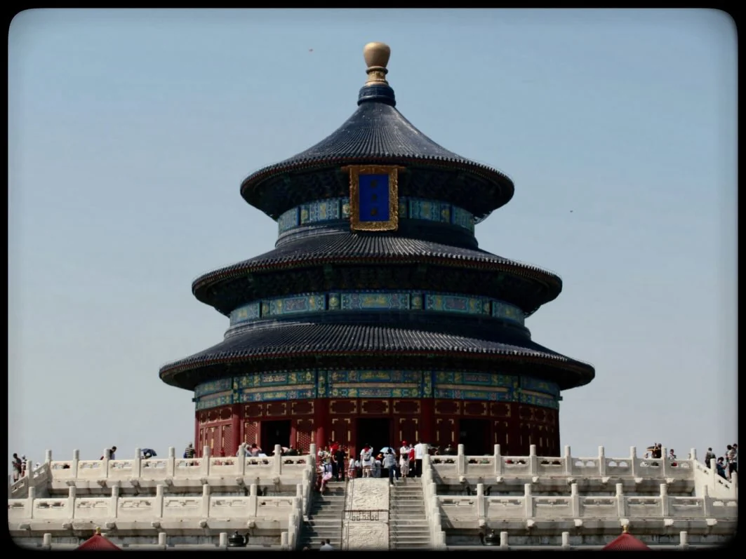The round, three-tiered Temple of Heaven in Beijing against a pale sky