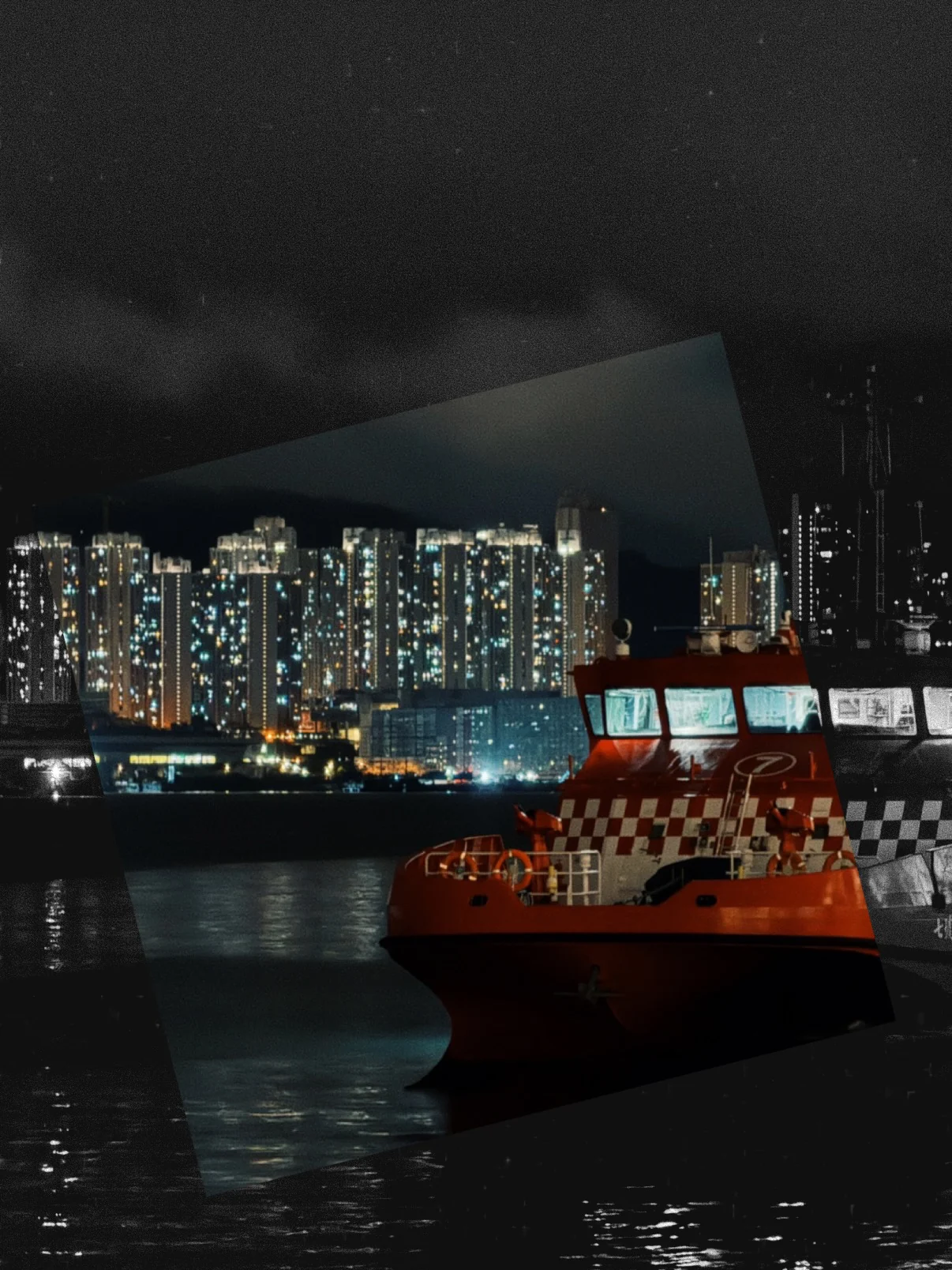 A red and white ferry on the harbour at night with lit towers behind